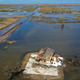 An aerial view from a drone shows a damaged home surrounded by water in Little Chenier, Louisiana following Hurricane Laura.